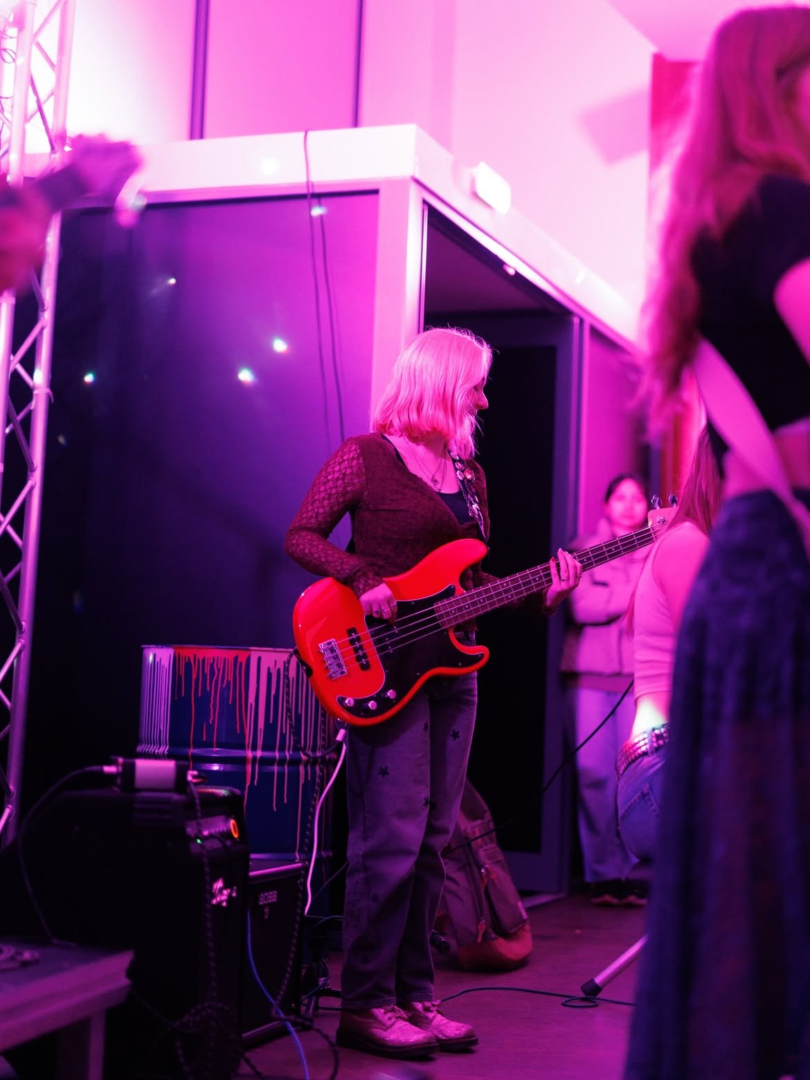 Lottie performing with a bass guitar